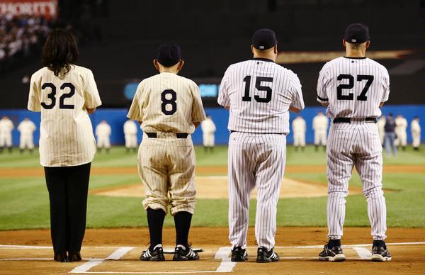 New York Yankees catcher Jorge Posada, left, walks off the field with  former Yankees catcher Yogi Berra after ceremonies at Yankee Stadium in New  York on Sunday, Sept. 21, 2008. The Yankees