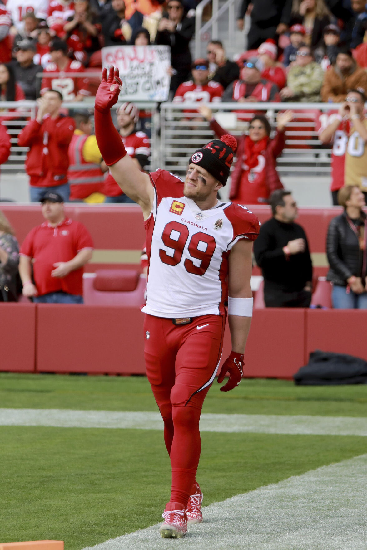 Arizona Cardinals' Will Hernandez (76) and J.J. Watt (99) walk off