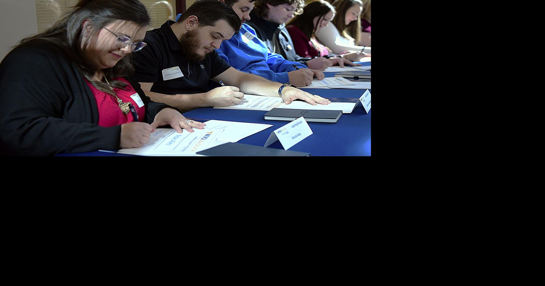 Twelve aspiring nursing students sign contract with WVU Medicine