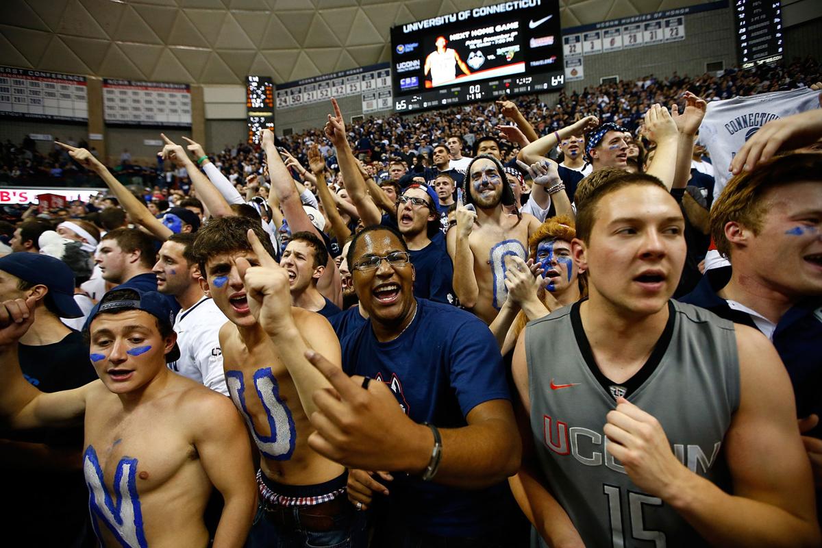 University of Connecticut fans celebrate following the last-second men's basketball win against Florida at Harry A. Gampel Pavilion on December 2, 2013, in Storrs, Conn. (Jared Wickerham/Getty Images/TNS) **FOR USE WITH THIS STORY ONLY**
