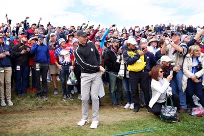 Rory McIlroy of Northern Ireland and team Europe plays his shot as fans look on during practice rounds prior to the 43rd Ryder Cup at Whistling Straits on September 23, 2021 in Kohler, Wisconsin.