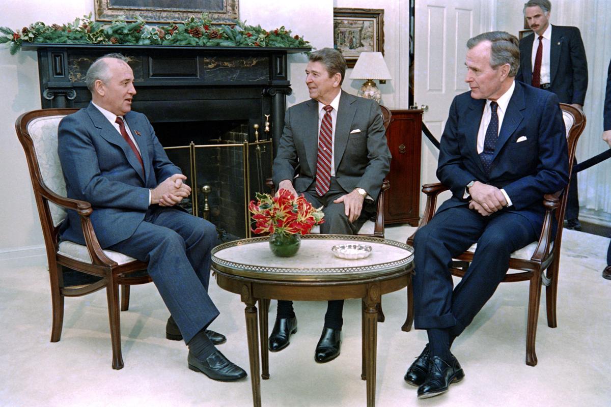 Soviet leader Mikhail Gorbachev, left, talks to President Ronald Reagan, middle, and President-elect George Bush, right, on December 7, 1988.