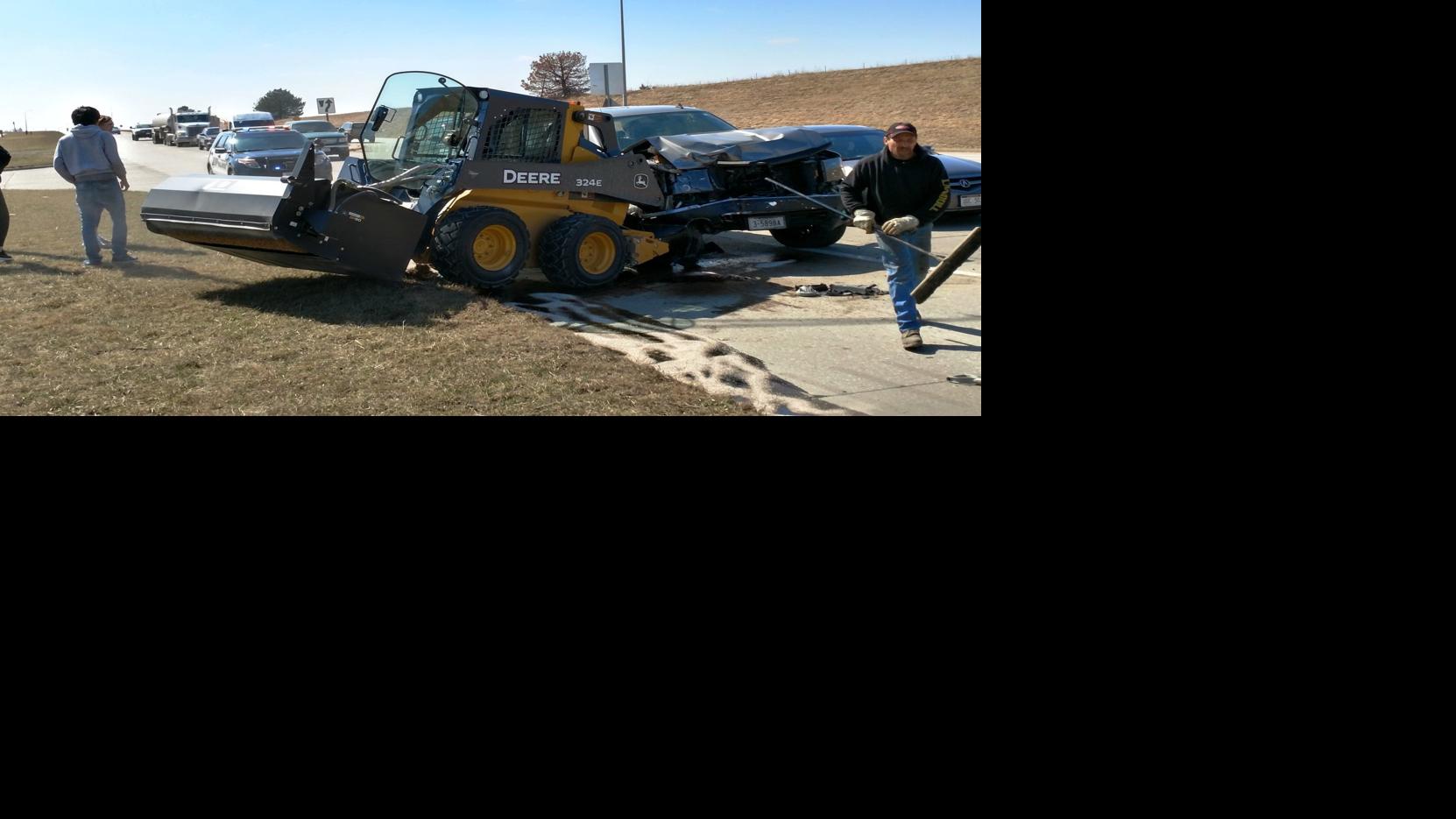 Truck hits skidloader on highway