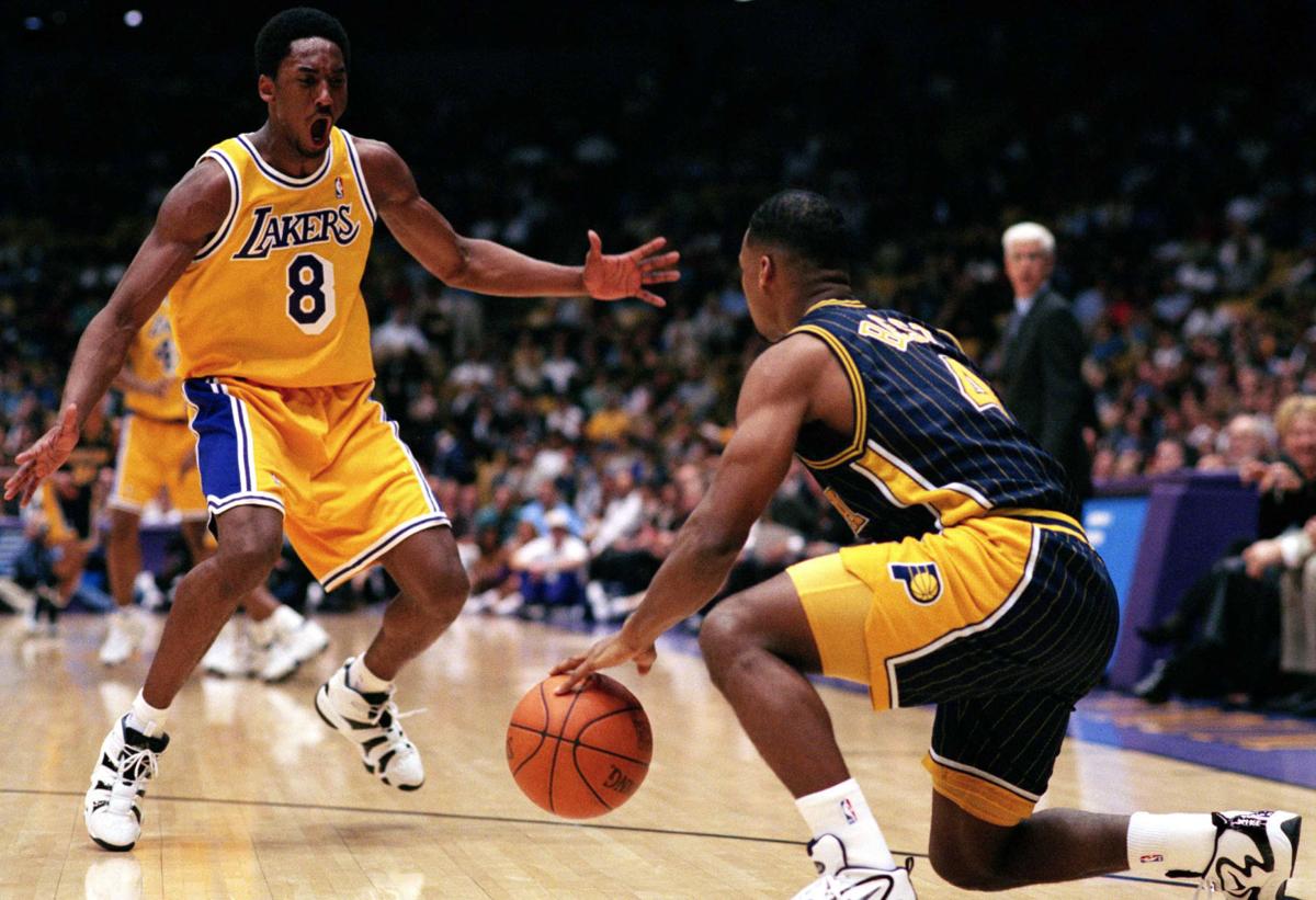FILE: Kobe Bryant of the Los Angeles Lakers flexes his bicep as he dribbles  the ball down court during a National Basketball Association game at the  Great Western Forum in Los Angeles