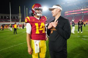 Southern California Trojans quarterback Jayden Maiava (14) and head coach Lincoln Riley react after the game against the UCLA Bruins at United Airlines Field at Los Angeles Memorial Coliseum.