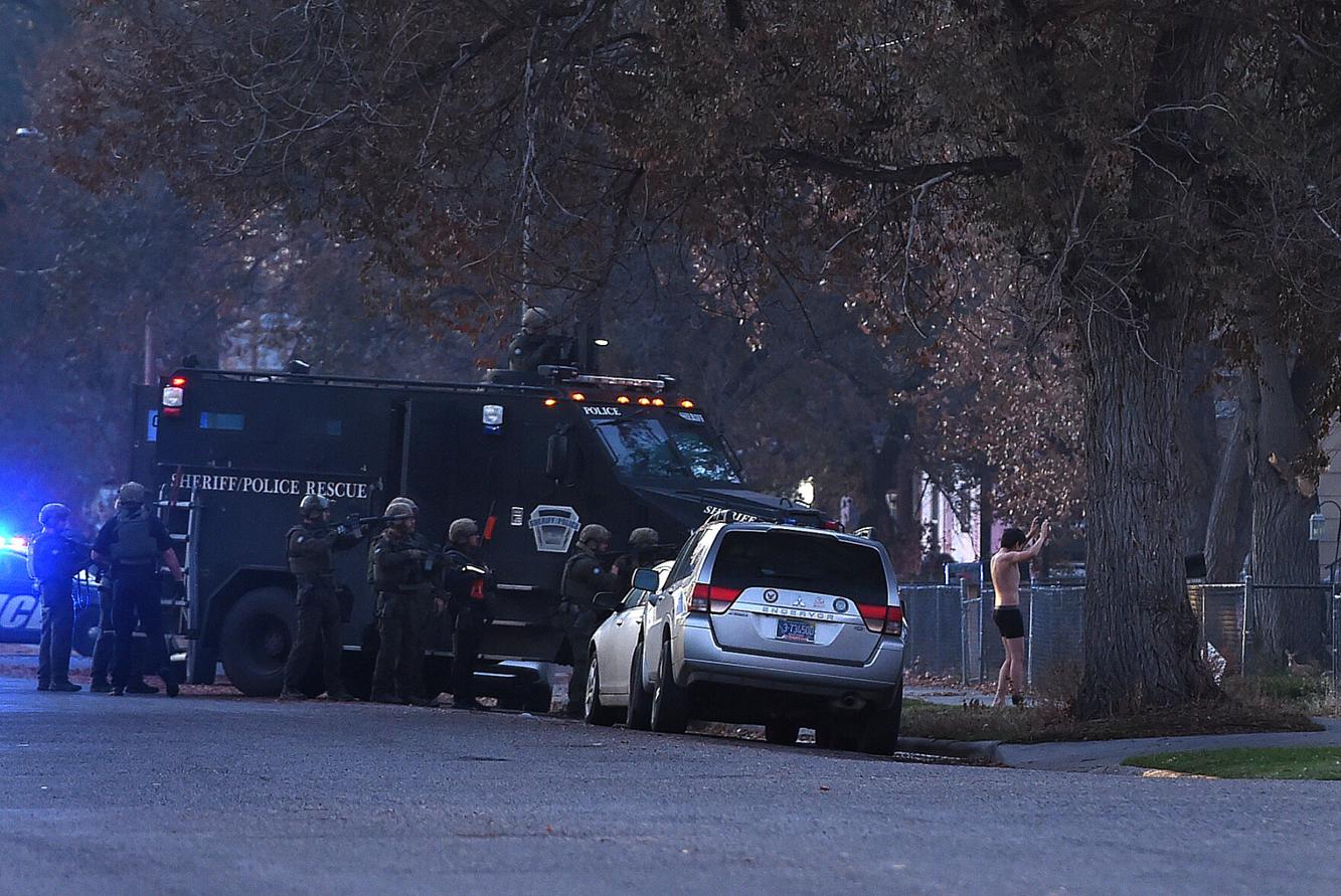 Billings police and Yellowstone County SWAT teams take residents from a house on South 31st Street on Saturday morning.
