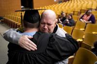 John Raines hugs his son Blake