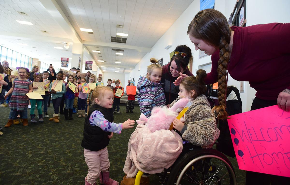 Girl paralyzed at crash welcomed airport by fellow Billings first-graders in home