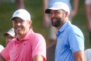 Rory McIlroy and Scottie Scheffler smile as they prepare to tee off on the first hole during the first round of the FedEx St.