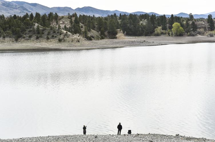 Two men fish from the bank of Canyon Ferry Reservoir