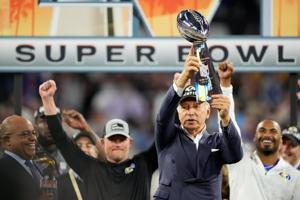 Los Angeles Rams owner Stan Kroenke raises the Lombardi Trophy at the conclusion of Super Bowl LVI between the Los Angeles Rams