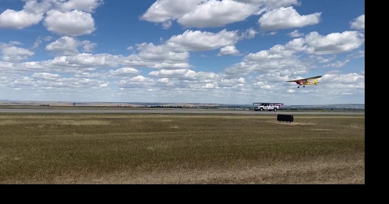 Antique plane lands on back of pickup truck during Billings airshow