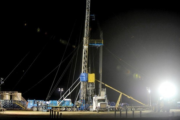 Workers operate a rig east of Sidney