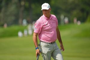 Stewart Cink walks across the eighth green during the first round of the U.S. Senior Open at Scioto Country Club in Columbus on