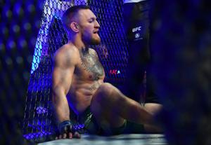 Conor McGregor reacts following an injury suffered against Dustin Poirier during UFC 264 at T-Mobile Arena in Las Vegas on July 10, 2021.
