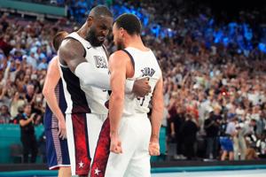 United States forward LeBron James and guard Stephen Curry celebrate after the game against Serbia in a men's basketball
