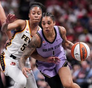 Golden State Valkyries forward Gabby Williams (1) drives against Indiana Fever guard Tyasha Harris (52).