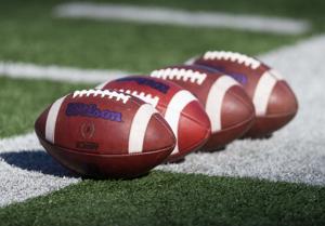 Sept. 30, 2017; Madison, Wisconsin; Footballs with the college football playoff logo sit on the field during warmups prior to the game between the Northwestern Wildcats and Wisconsin Badgers at Camp Randall Stadium.