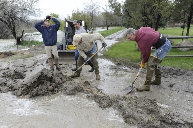 Debris built up under bridge causes flood in Joliet