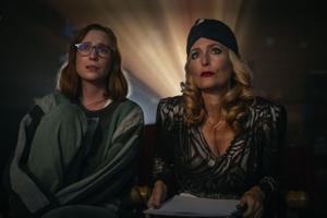 Hannah Einbinder and Gillian Anderson watch a film in 'Teenage Sex and Death at Camp Miasma.'