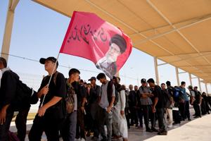 Iranian Shi'ite pilgrims enter Iraq through the Shalamcheh border crossing to make their way to the holy city of Karbala to attend the annual Arbaeen pilgrimage, following U.S. strikes on the Iranian side of the border crossing, in Basra
