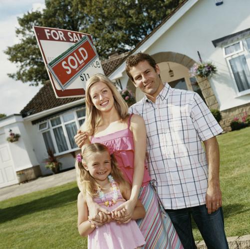 Couple in front of new home