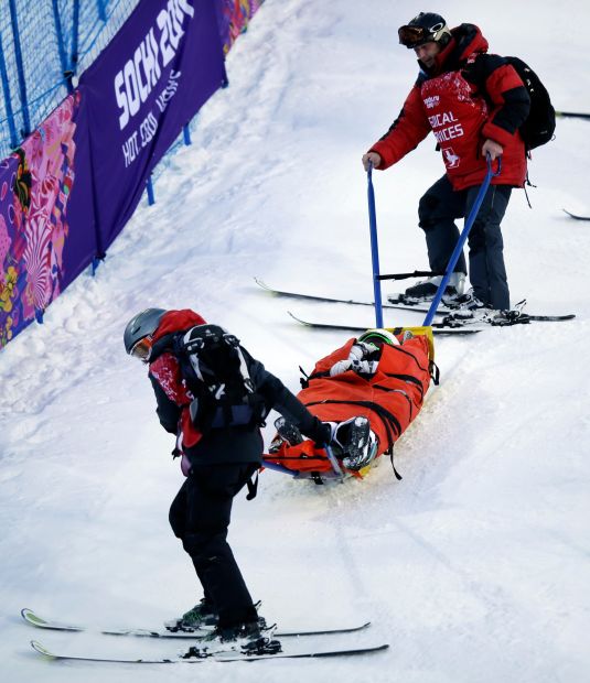 The United States' Heidi Kloser is stretchered off the course