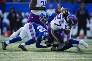 New York Giants linebacker Bobby Okereke (58) tackles Minnesota Vikings running back Jordan Mason (27) during a game at MetLife Stadium, Dec 21, 2025, East Rutherford, NJ, USA