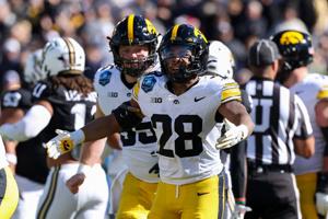 Dec 31, 2025; Tampa, FL, USA; Iowa Hawkeyes running back Kamari Moulton (28) reacts after a touchdown against the Vanderbilt Commodores in the first quarter during the ReliaQuest Bowl at Raymond James Stadium. Mandatory Credit: Nathan Ray Seebeck-Ima