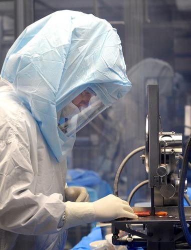 Band saw cuts pieces of human bone material
