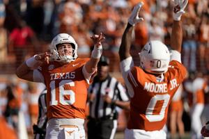 Texas Longhorns quarterback Arch Manning (16) reacts after throwing a touchdown pass in the first half against the Arkansas Razorbacks at Darrell K Royal-Texas Memorial Stadium.