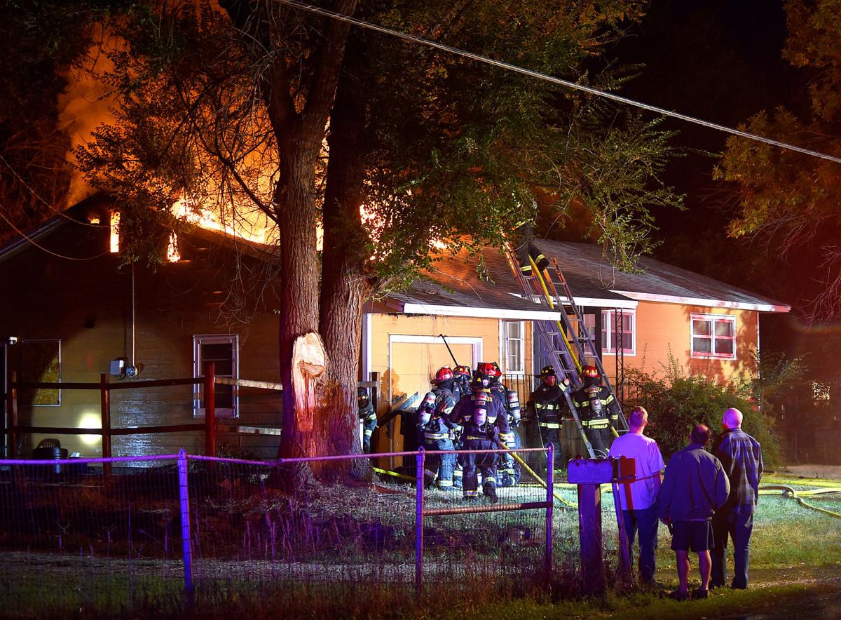 Firefighters battle a house fire on Wicks Lane