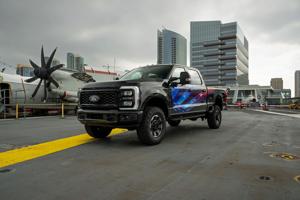 The limited-edition Super Duty Proud to Honor F-250. This all-purpose-built truck features striking red, white, and blue styling, darkened exterior trim, and aggressive black wheels.