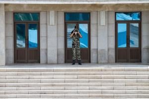 A North Korean soldier observes the DMZ.