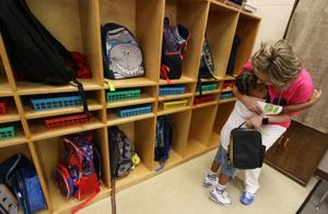Kindergarten student Trenton Allison gives Jada Huss a hug Wednesday morning, Aug. 12, 2026 for the first day of school at West Elementary School in Kings Mountain.