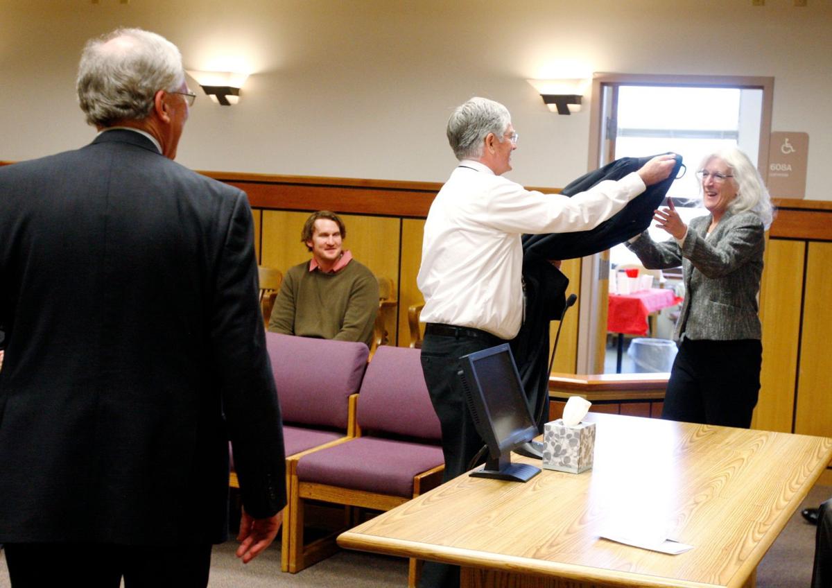 Sitting judge gives new judge the robe off his shoulders for his