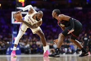 Los Angeles Lakers forward Lebron James (23) controls the ball against Philadelphia 76ers guard Tyrese Maxey during the first quarter at Xfinity Mobile Arena on Dec. 7, 2025.