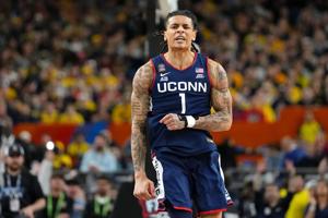 UConn Huskies guard Solo Ball (1) reacts after a play against the Michigan Wolverines during the first half in the national championship of the Final Four of the men's 2026 NCAA Tournament between the and the Michigan Wolverines at Lucas Oil Stadium.