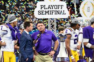 Dec 28, 2019; Atlanta, Georgia, USA; LSU Tigers head coach Ed Orgeron celebrates with the trophy after the 2019 Peach Bowl college football playoff semifinal game between the LSU Tigers and the Oklahoma Sooners at Mercedes-Benz Stadium. Mandatory Cre