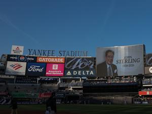 The main scoreboard displays a message honoring John Sterling, the Yankees radio play-by-play announcer before the game between the New York Yankees and Baltimore Orioles at Yankee Stadium on May 4, 2026.