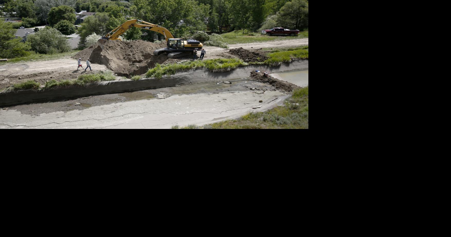 Irrigation company drains and digs up ditch above waterlogged homes in