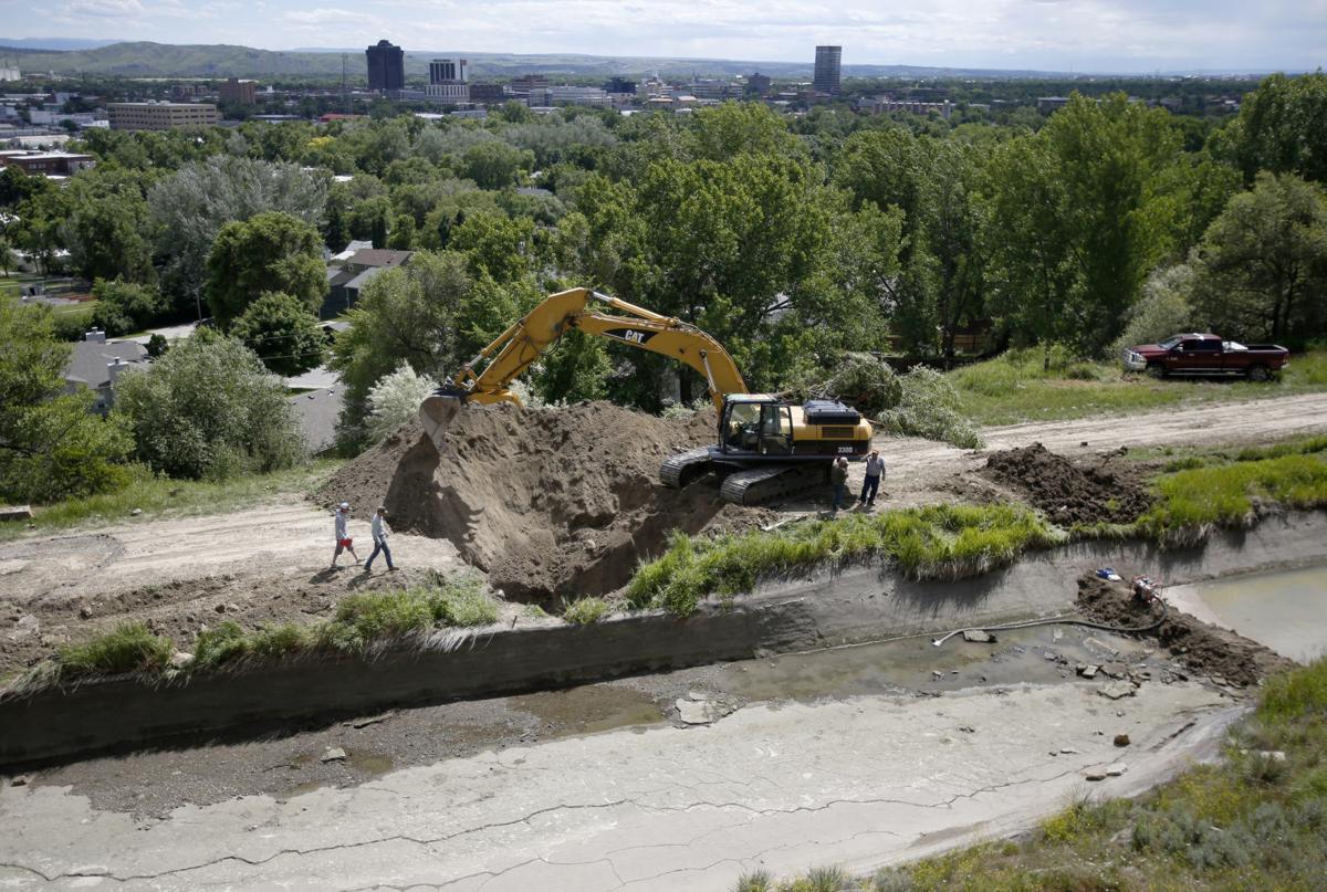 Irrigation company drains and digs up ditch above waterlogged homes in