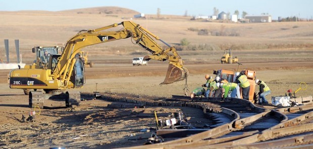 Railroad workers build tracks
