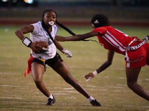 Oct. 2, 2025; Tuscaloosa, Alabama, USA; Northridge's Jiayiah Lee (2) tries to evade a flag pull by Central's Alaysha Merriweather (5) at Central High School.