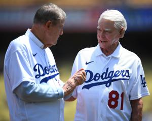 Former Dodgers general manager Fred Claire talks with former owner Peter O'Malley before a 2021 ceremony at Dodger Stadium.