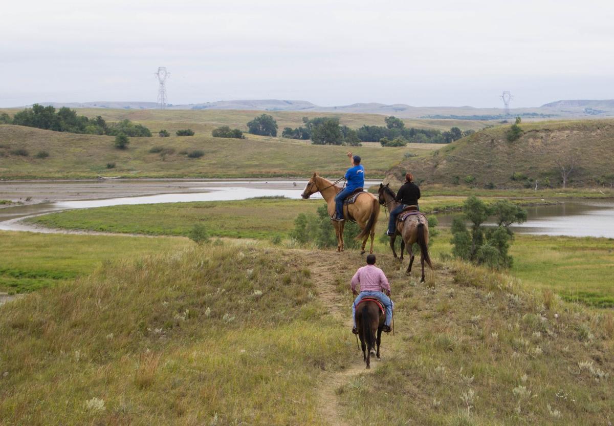 A group rides horses