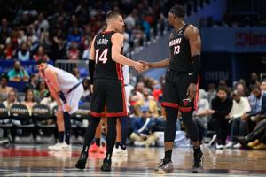 Mar 31, 2025; Washington, District of Columbia, USA; Miami Heat guard Tyler Herro (14) and center Bam Adebayo (13) react during the third quarter against the Washington Wizards at Capital One Arena. Mandatory Credit: Reggie Hildred-Imagn Images
