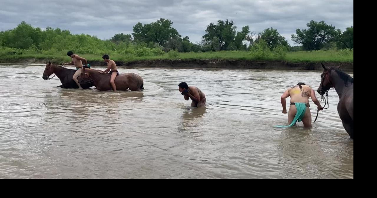Warriors wash off war paint after Little Big Horn battle reenactment