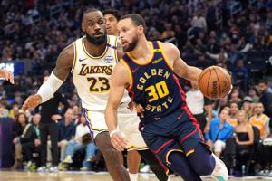 Golden State Warriors guard Stephen Curry (30) dribbles against Los Angeles Lakers forward LeBron James (23) during a January 2025 game.