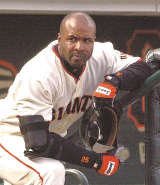 San Francisco Giants' Barry Bonds removes his batting helmet as he